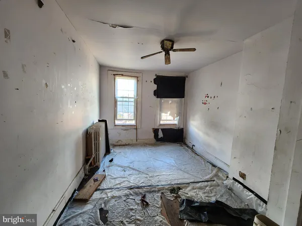a view of a livingroom with furniture and a window