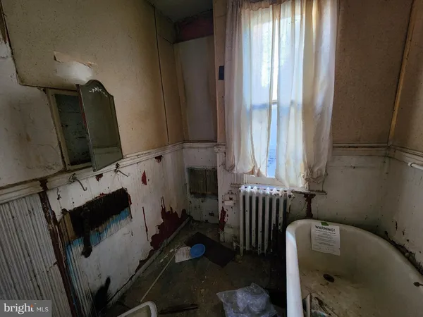 a bathroom with a bathtub sink and window
