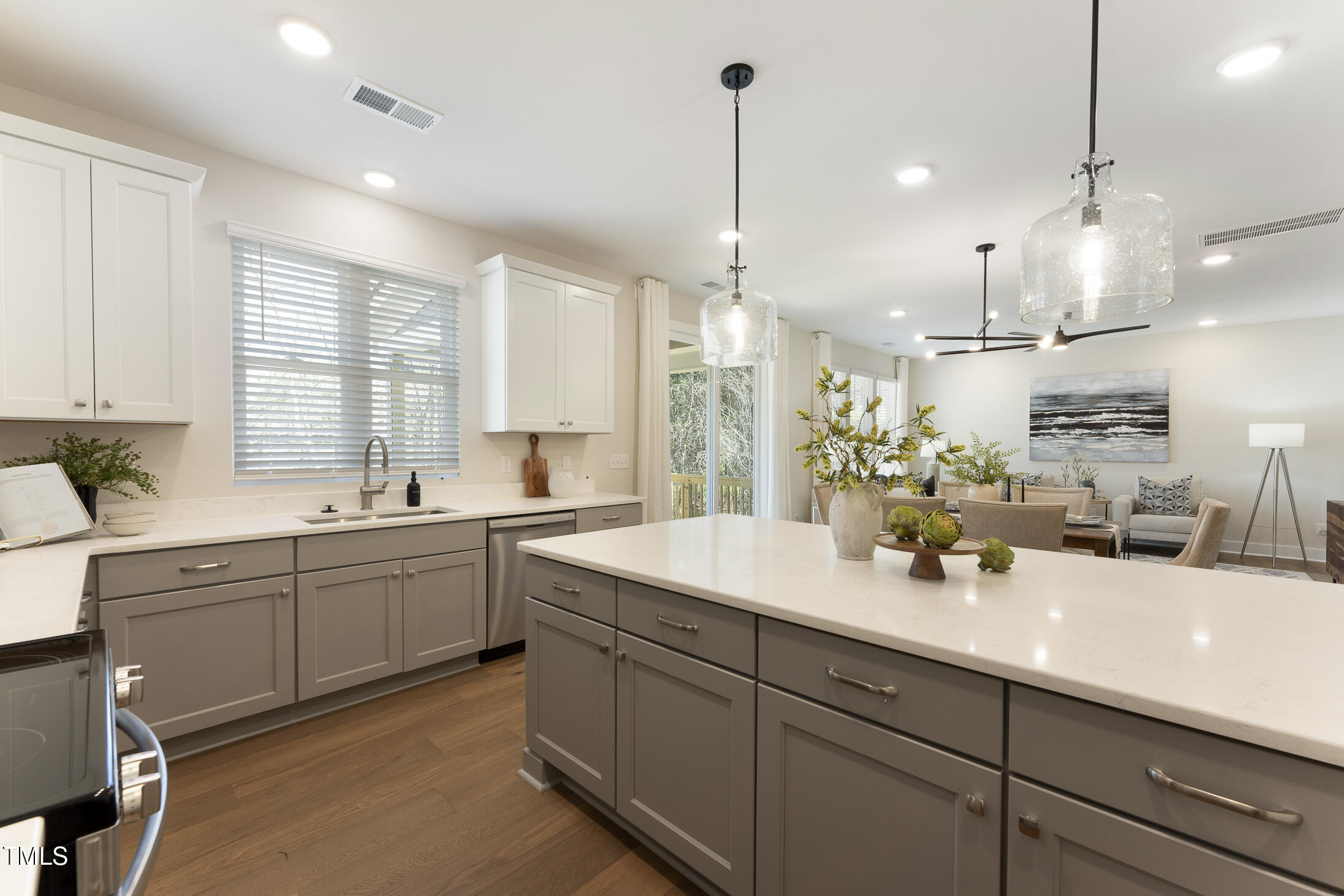 604 Whistable Avenue Wake Forest, NC 27587 - Photo 12 of 44 a kitchen with kitchen island granite countertop a sink a counter space appliances and cabinets