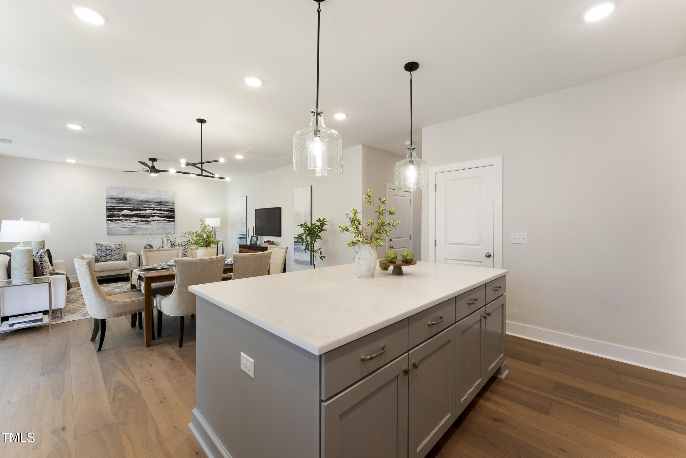 604 Whistable Avenue Wake Forest, NC 27587 - Photo 13 of 44 a large kitchen with kitchen island a island a sink a stove and wooden floor