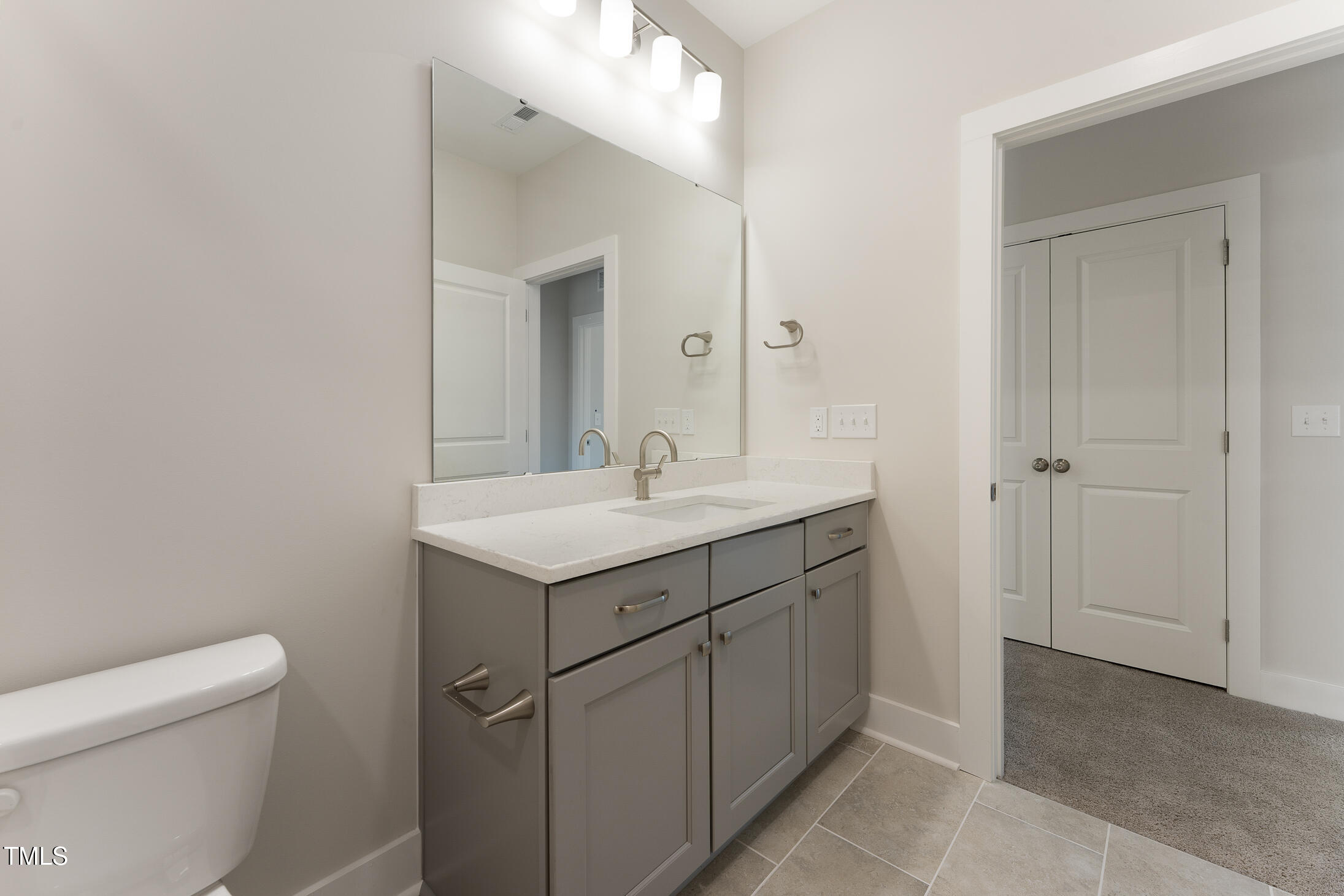 604 Whistable Avenue Wake Forest, NC 27587 - Photo 36 of 44 a bathroom with a sink toilet and vanity