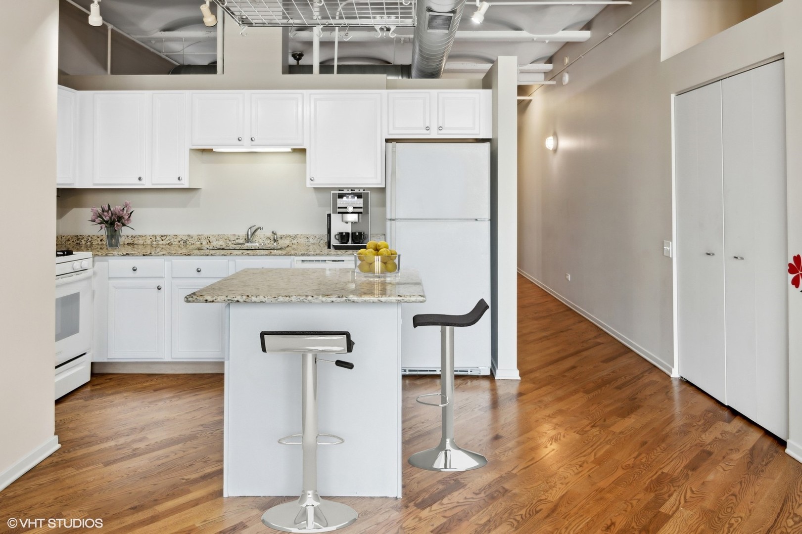 500 South Clinton Street, Unit 541 Chicago, IL 60607 - Photo 8 of 21 a kitchen with a sink cabinets and wooden floor