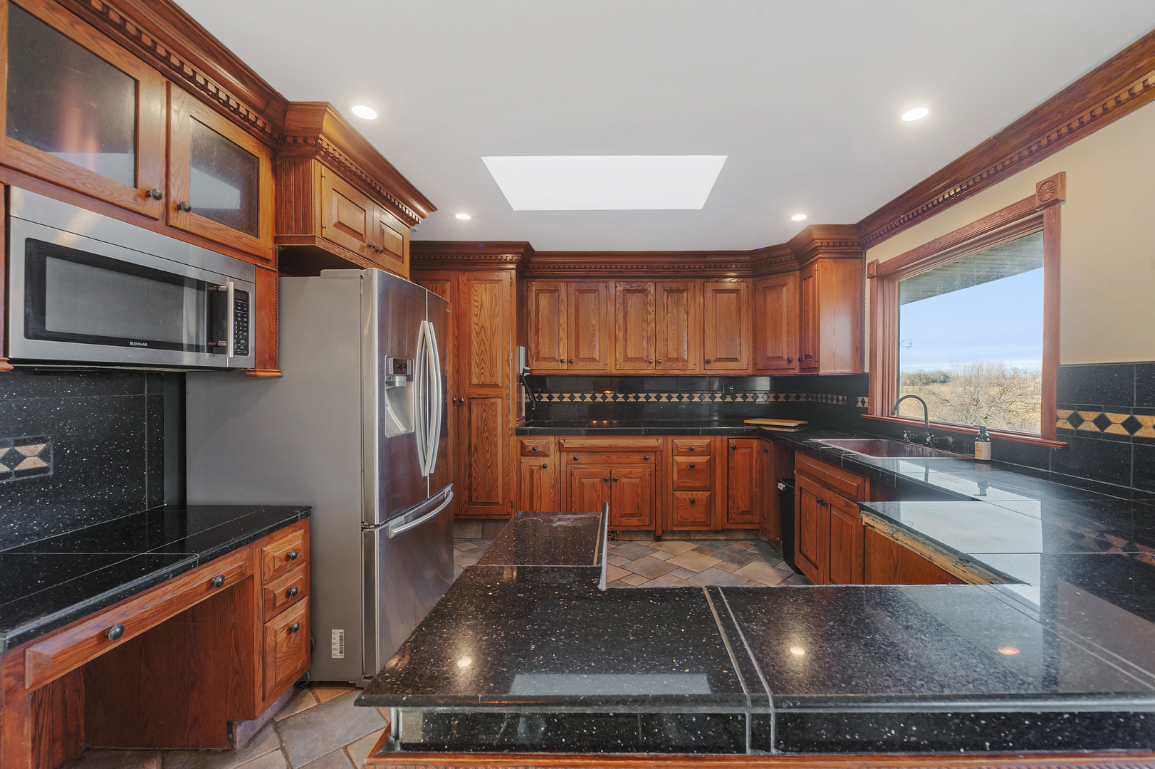28766 West Burnett Road McHenry, IL 60051 - Photo 5 of 19 a kitchen with stainless steel appliances granite countertop a refrigerator a stove and a sink with wooden cabinets