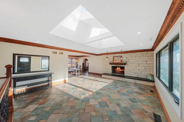 a view of a livingroom with entryway and fireplace
