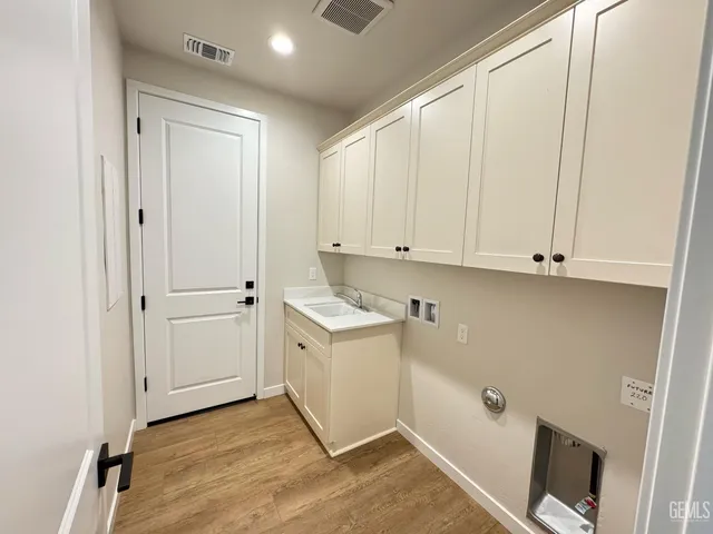 a view of cabinets and wooden floor