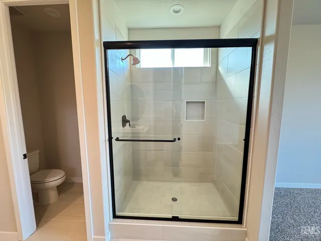 a bathroom with a glass shower door