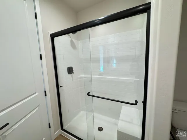 a bathroom with a glass shower door