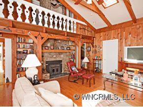 1348 Saunook Road Waynesville, NC 28786 - Photo 2 of 24 a living room with furniture a fireplace and a flat screen tv
