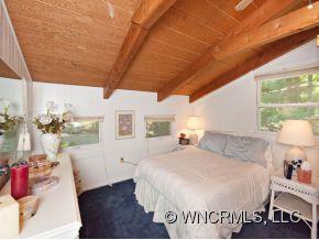 1348 Saunook Road Waynesville, NC 28786 - Photo 11 of 24 a spacious bedroom with a bed and a window