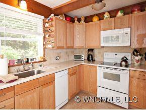 1348 Saunook Road Waynesville, NC 28786 - Photo 4 of 24 a kitchen with a sink cabinets and window