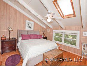 1348 Saunook Road Waynesville, NC 28786 - Photo 9 of 24 a bedroom with a large bed and a window
