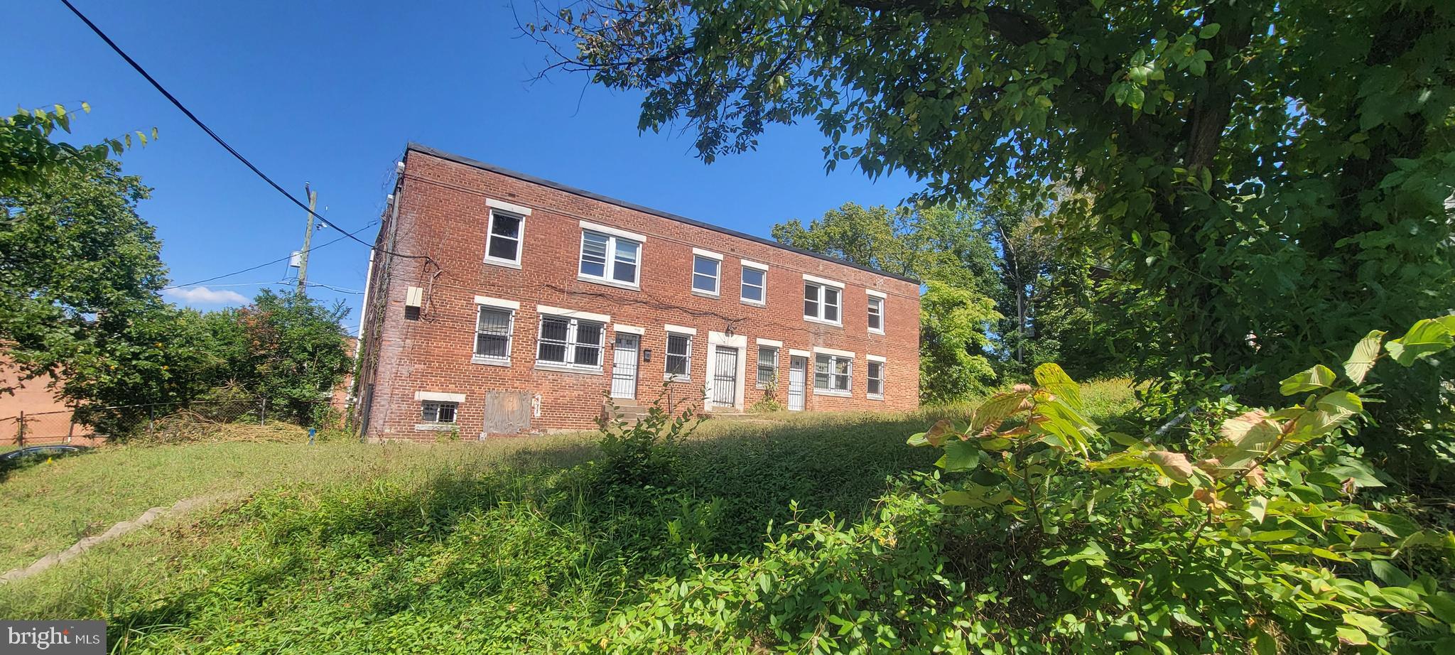 4962-4966 Benning Road Southeast Washington, DC 20019 - Photo 2 of 13 a view of a building with a yard