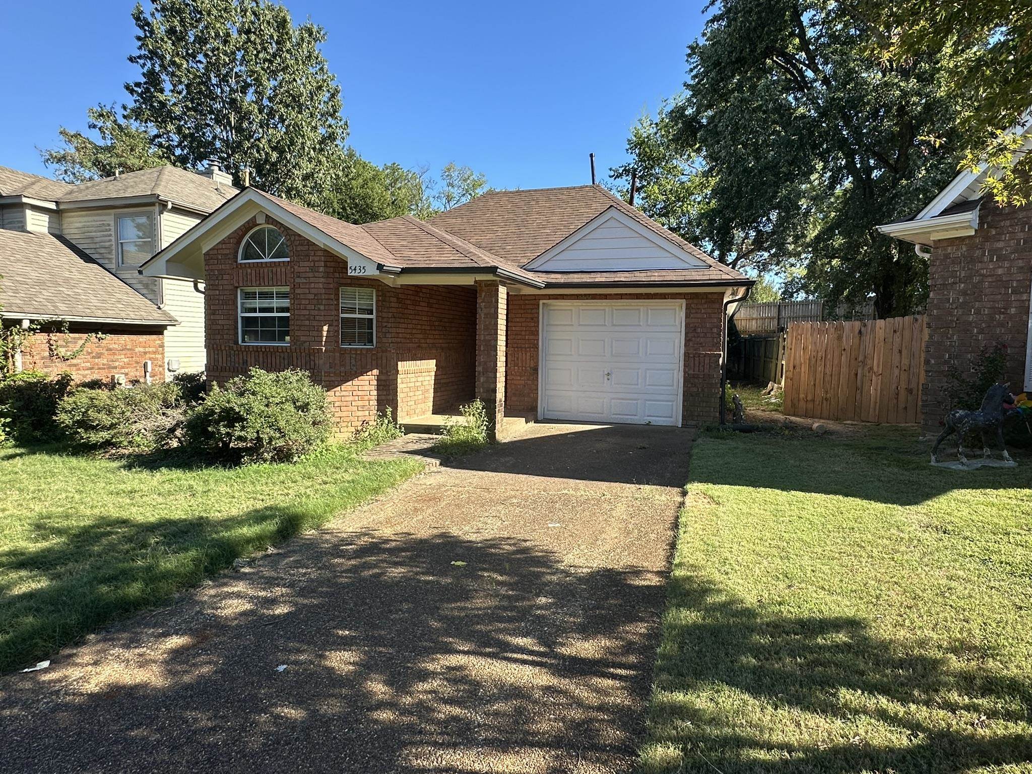 5435 Pine Oak Lane Bartlett, TN 38135 - Photo 2 of 17 a front view of house with yard and trees in the background