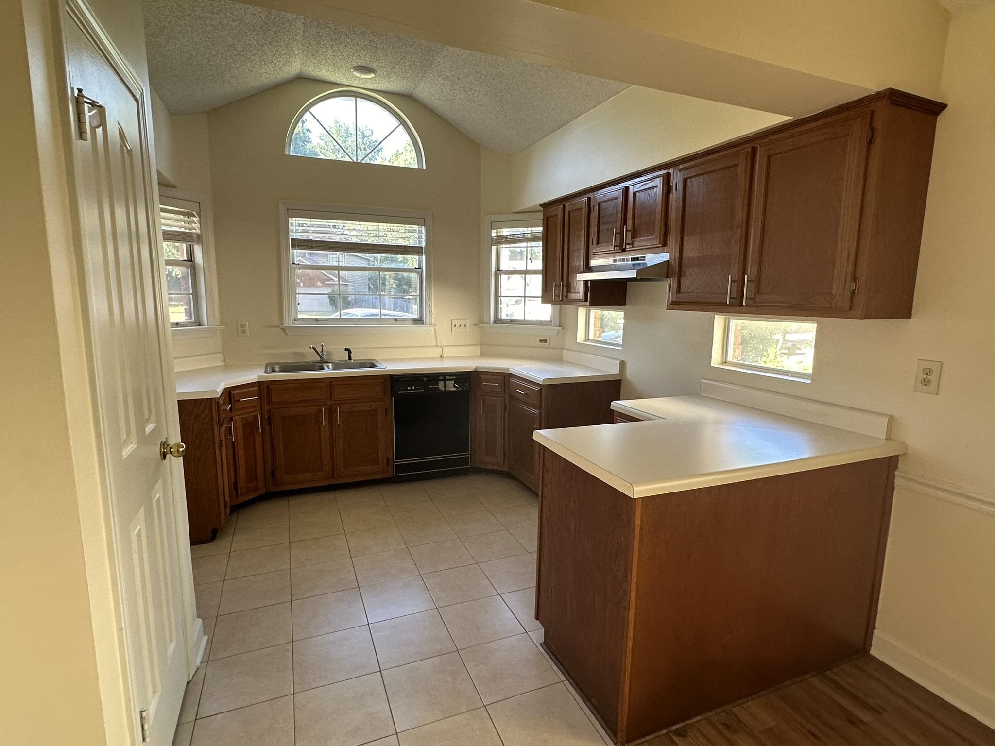 5435 Pine Oak Lane Bartlett, TN 38135 - Photo 4 of 17 a kitchen with stainless steel appliances granite countertop a sink counter space cabinets and a window