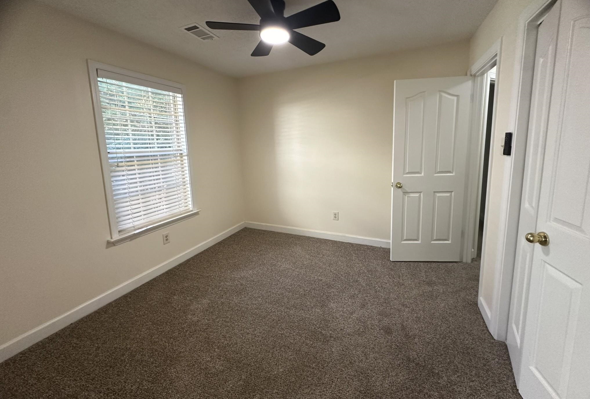 5435 Pine Oak Lane Bartlett, TN 38135 - Photo 5 of 17 an empty room with windows and fan