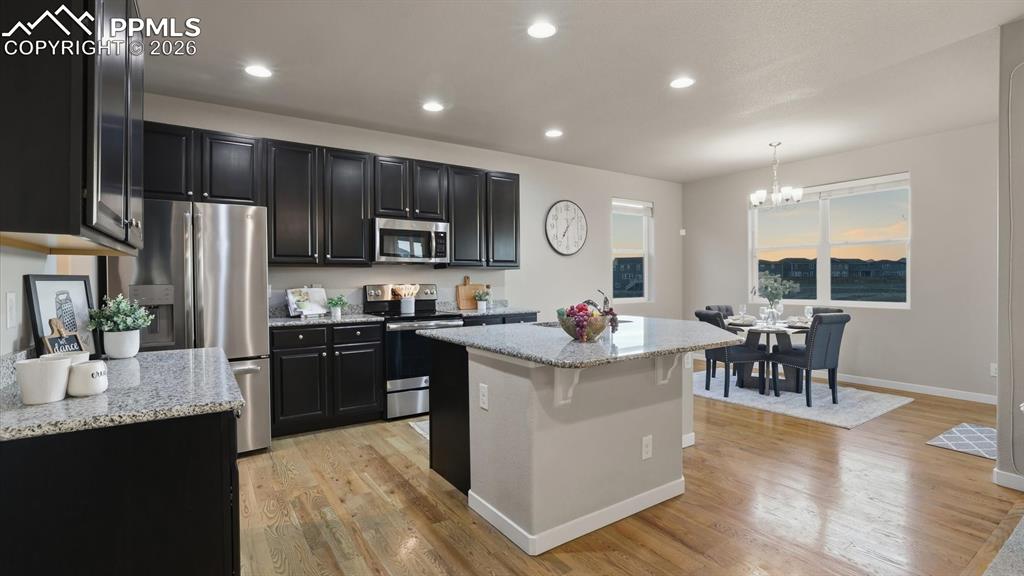 7872 Callendale Drive Colorado Springs, CO 80908 - Photo 13 of 50 The gourmet island kitchen offers a breakfast bar, espresso cabinetry, granite countertops, and stainless steel appliances.