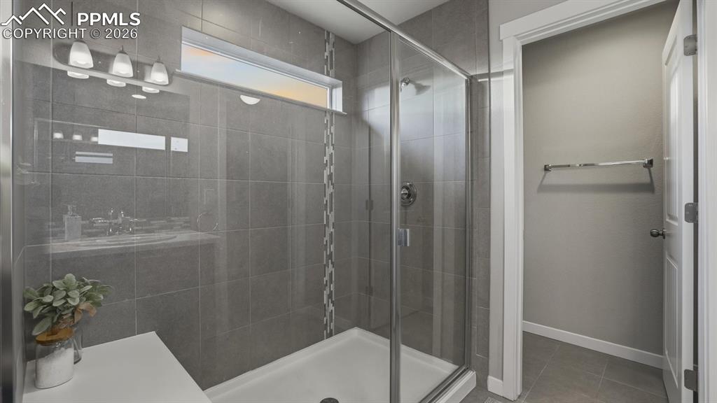 7872 Callendale Drive Colorado Springs, CO 80908 - Photo 26 of 50 Enclosed tiled shower with built in seat and toilet room in the Primary Bathroom.