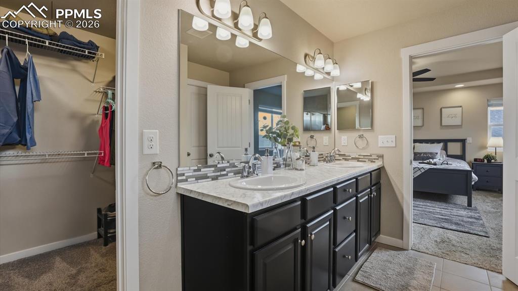 7872 Callendale Drive Colorado Springs, CO 80908 - Photo 27 of 50 View of walk in closet and Primary Bedroom from the Primary Bathroom.