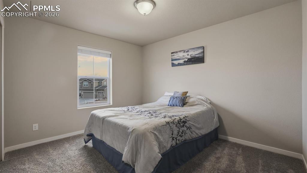 7872 Callendale Drive Colorado Springs, CO 80908 - Photo 30 of 50 Upper Level Bedroom #2 with neutral carpet.