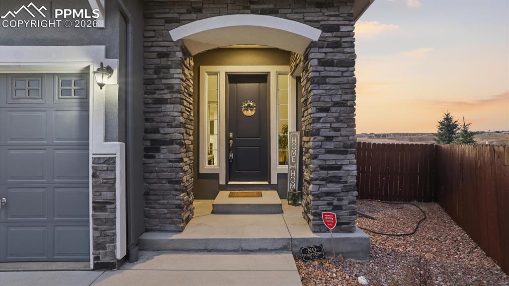 7872 Callendale Drive Colorado Springs, CO 80908 - Photo 4 of 50 Covered, arched entry with stone accent.