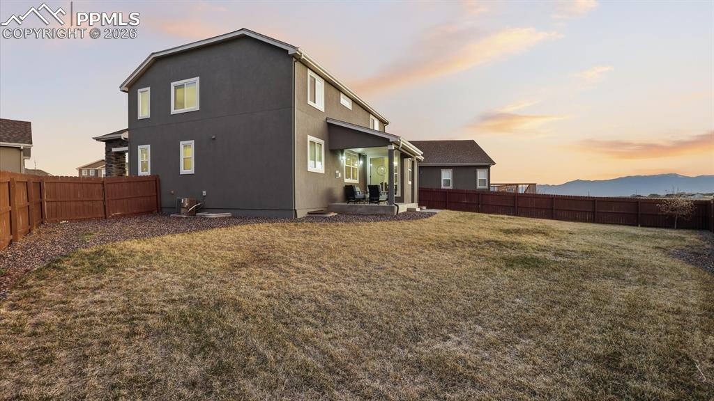7872 Callendale Drive Colorado Springs, CO 80908 - Photo 48 of 50 Large fenced yard with auto sprinklers, a covered patio, and beautiful mountain views.