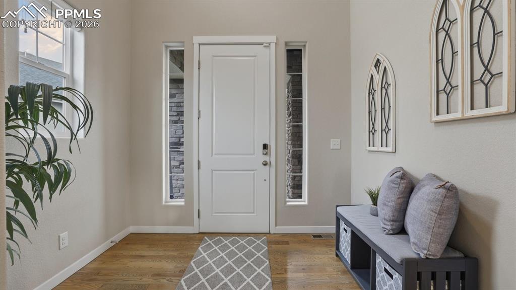 7872 Callendale Drive Colorado Springs, CO 80908 - Photo 5 of 50 Interior front foyer with with side lite door and gleaming wood floors.