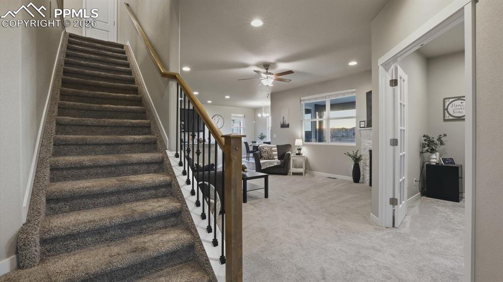 7872 Callendale Drive Colorado Springs, CO 80908 - Photo 9 of 50 View of stairs to the upper level, French doors into the home office, and Living Room from the Entry hallway.