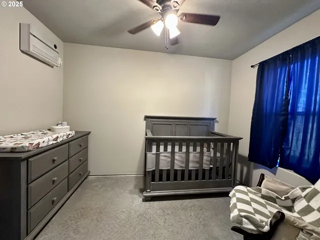 a bedroom with bed and wooden floor
