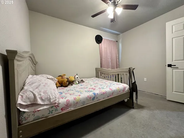 a bedroom with bed and a chandelier