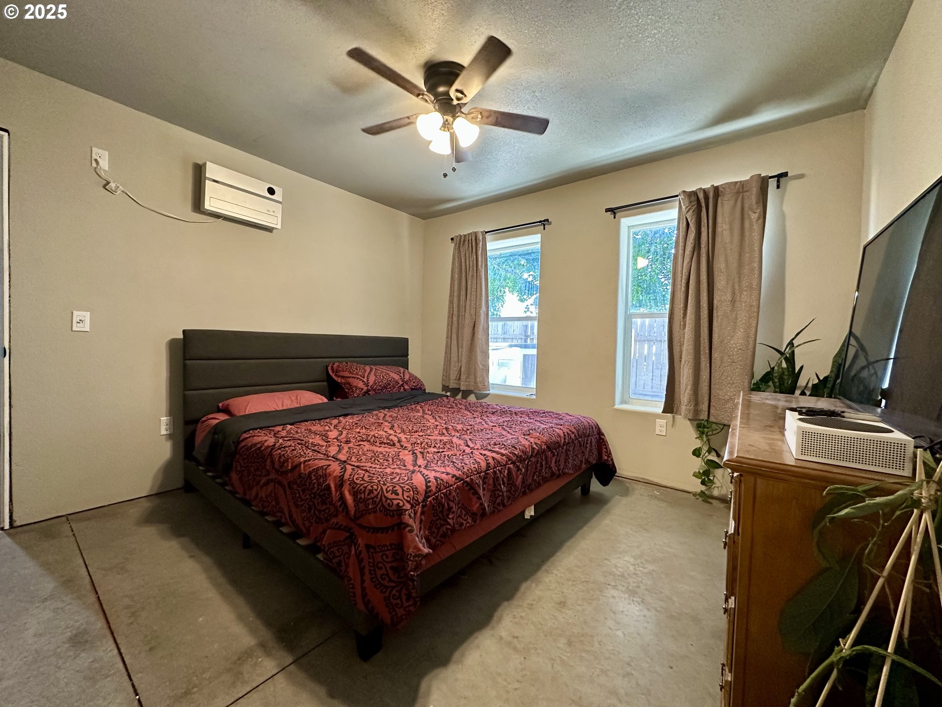 416 4th Street Summerville, OR 97876 - Photo 19 of 40 a spacious bedroom with a bed and a chandelier