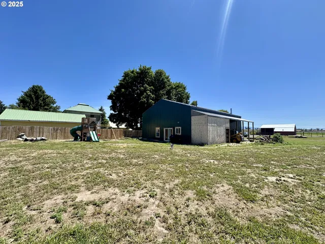 a big house with big yard plants and large trees