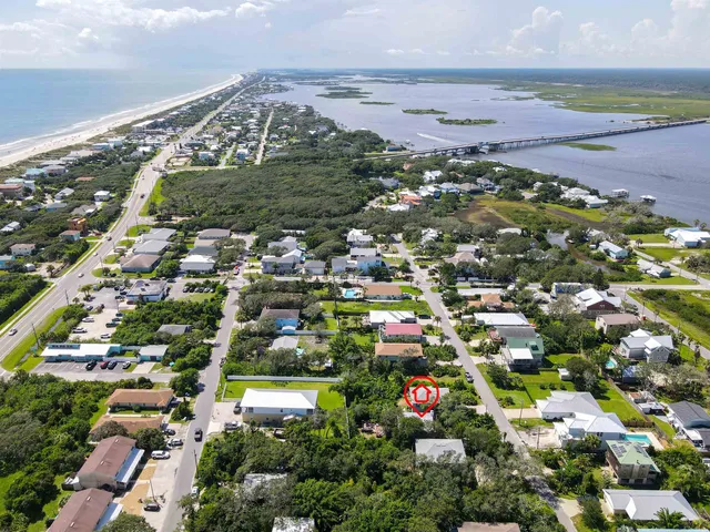an aerial view of a houses with a yard
