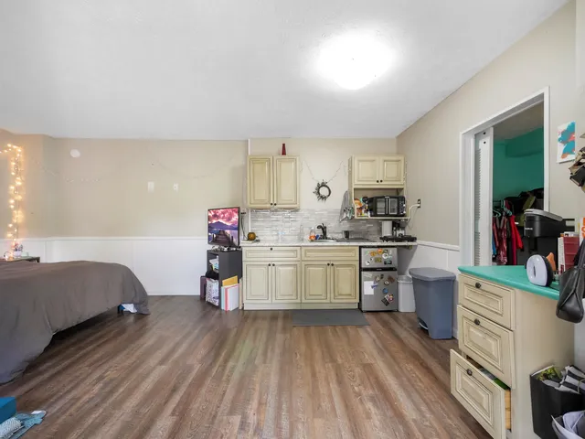 a view of a hallway with wooden floor and entryway