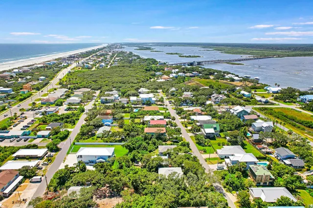 a view of a patio with a table and chairs under an umbrella