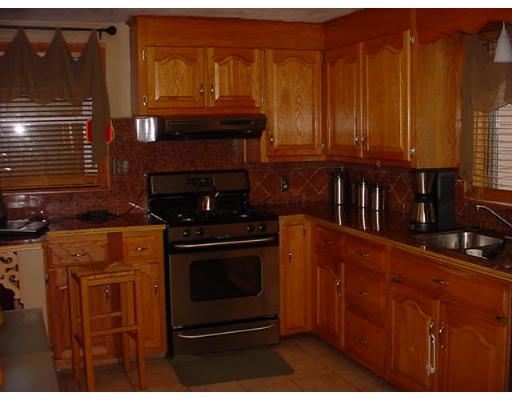252 Oak Street Springfield, MA 01151 - Photo 3 of 10 a kitchen with granite countertop a stove top oven cabinetry and granite counter