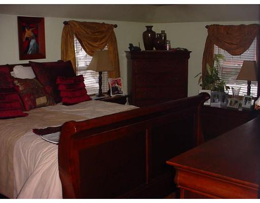 252 Oak Street Springfield, MA 01151 - Photo 8 of 10 a bed sitting in a bedroom next to a window