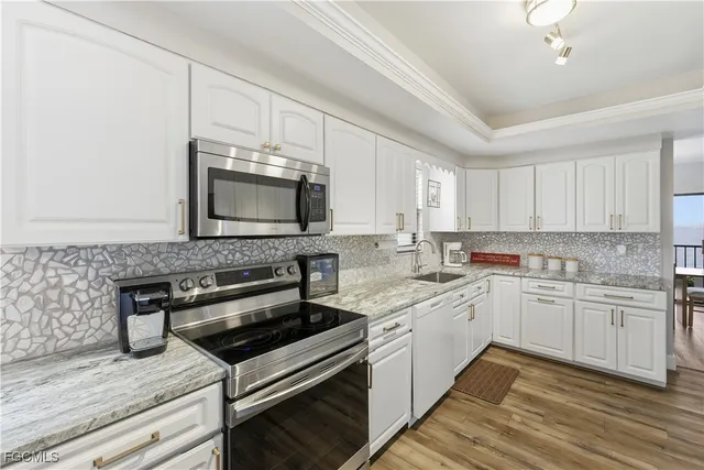 a kitchen with a sink stove and microwave