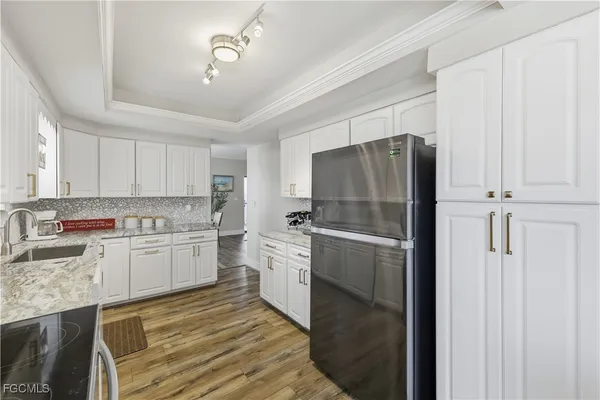 a kitchen with a refrigerator and a sink