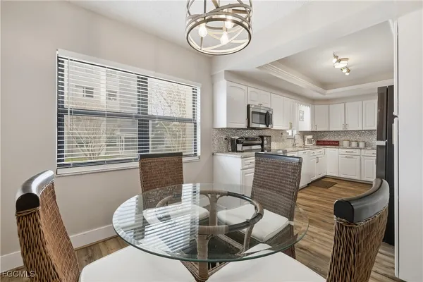 a living room with furniture kitchen and a large window