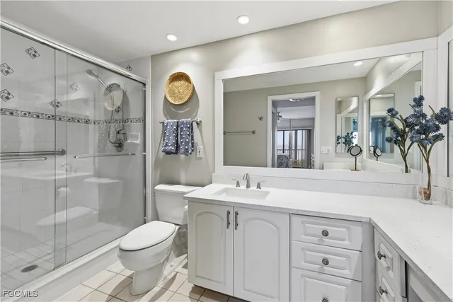 a bathroom with a sink vanity mirror and toilet