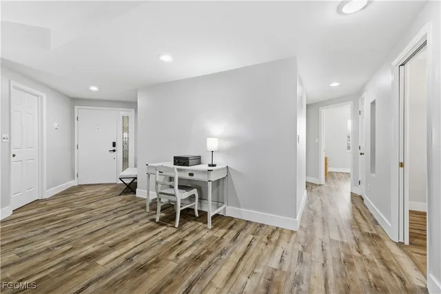 a view of a room with wooden floor a bed and a window