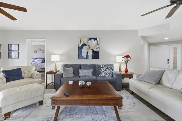 a living room with furniture a rug and a window