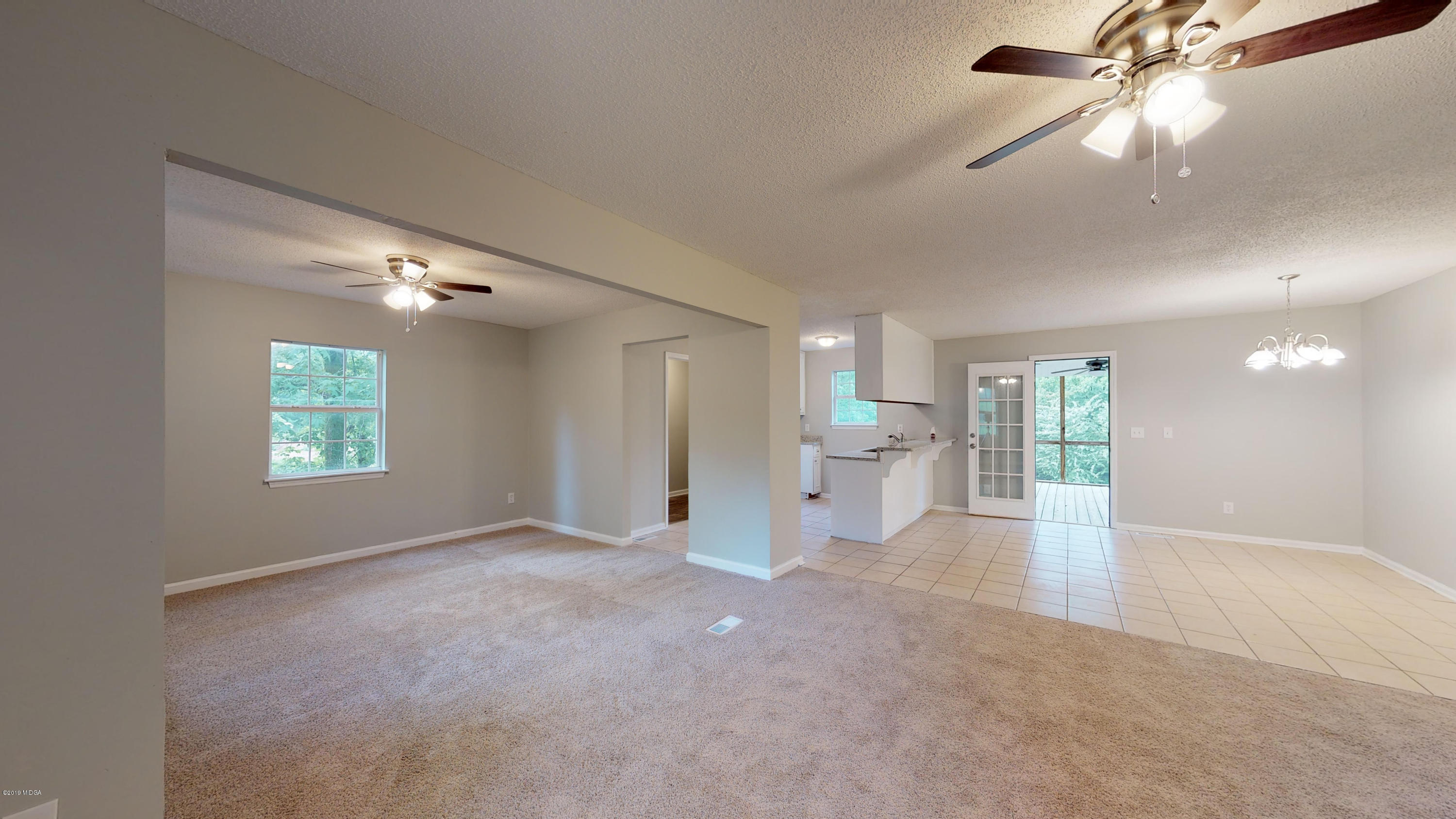 639 Lassiter Road Forsyth, GA 31029 - Photo 14 of 25 an empty room with fan and windows