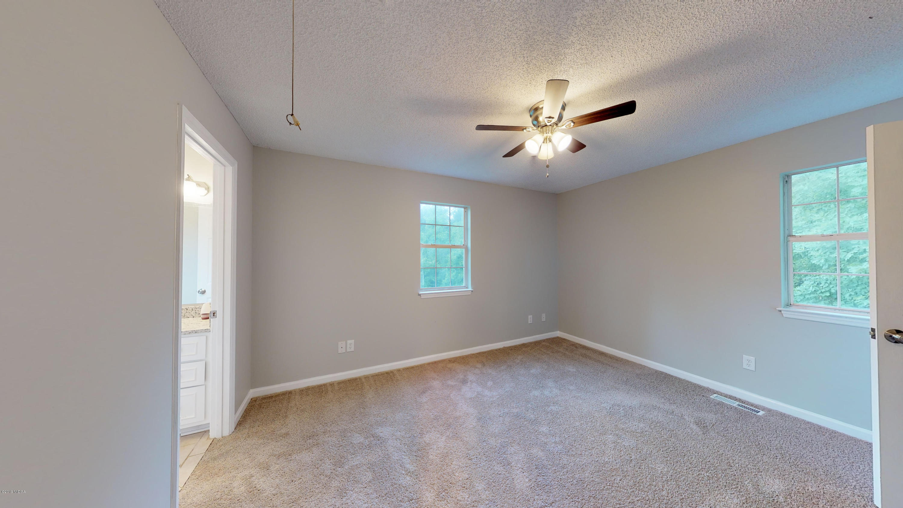 639 Lassiter Road Forsyth, GA 31029 - Photo 3 of 25 a view of an empty room with a window