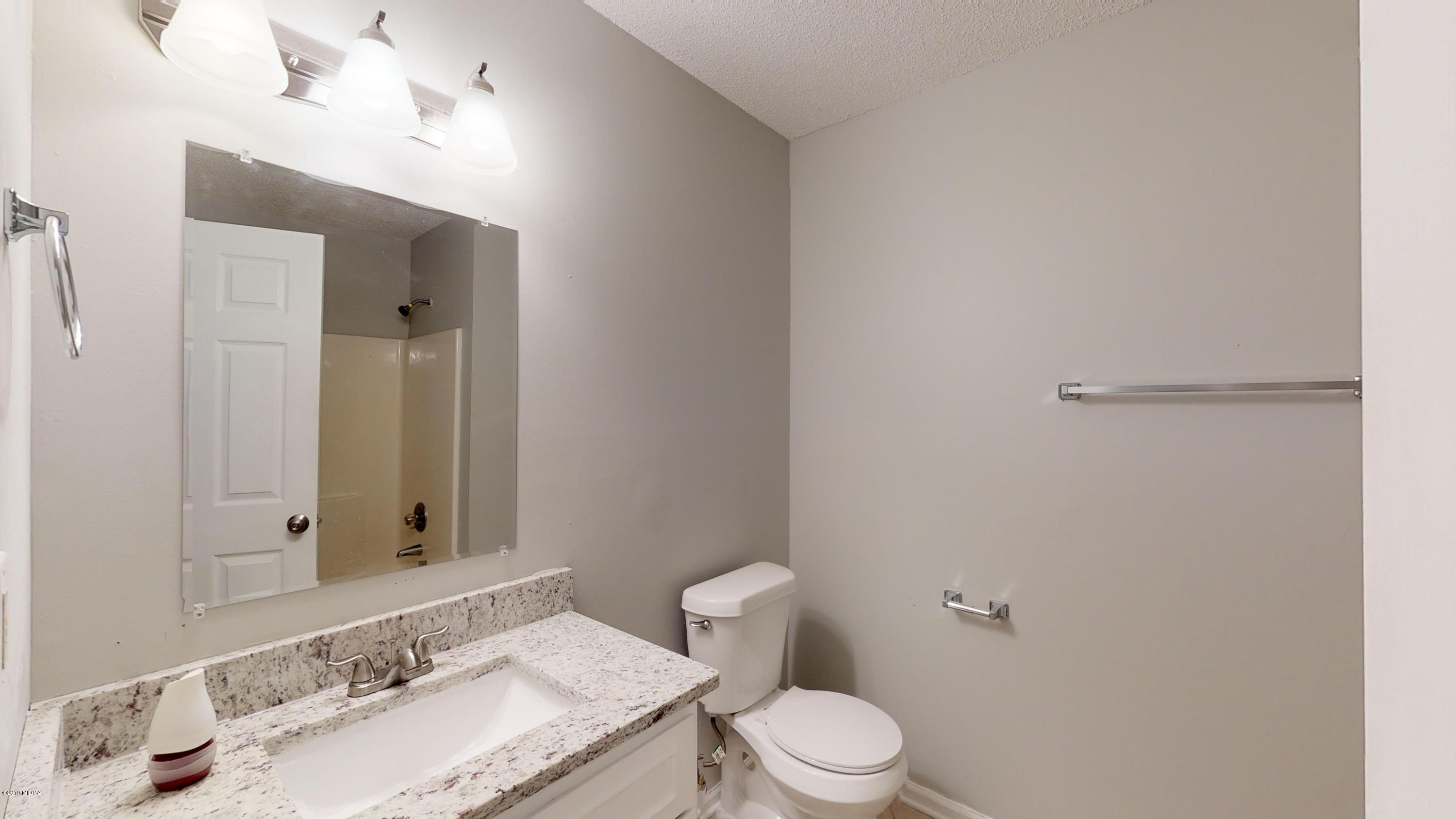 639 Lassiter Road Forsyth, GA 31029 - Photo 8 of 25 a bathroom with a sink and a toilet