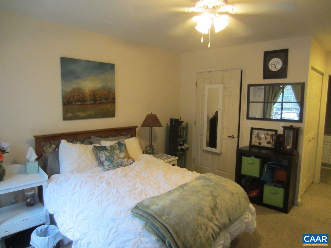 1420 Lilac Court Charlottesville, VA 22901 - Photo 7 of 15 a bedroom with a bed and a chandelier