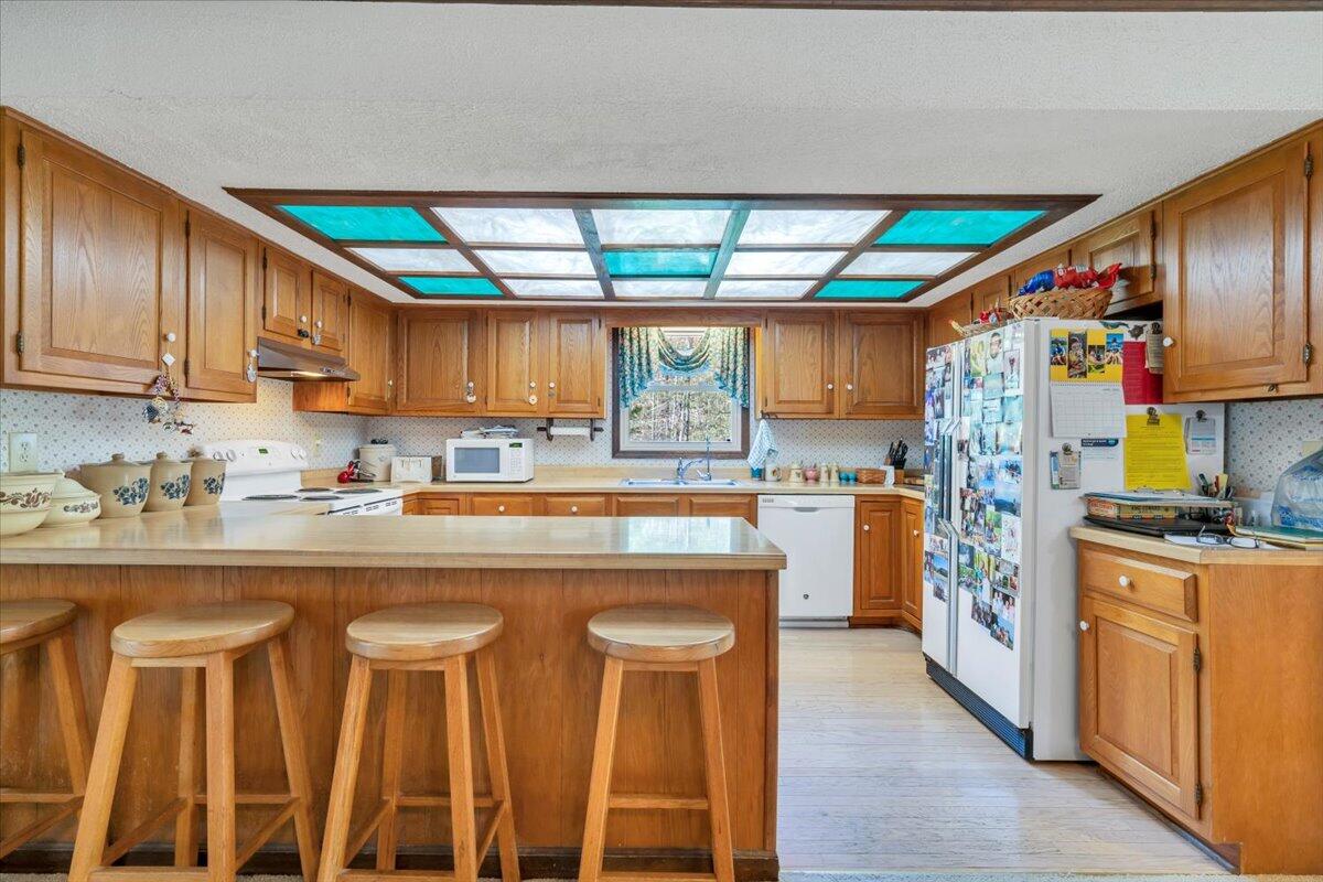 3878 Harborwood Road Salem, VA 24153 - Photo 19 of 60 a kitchen with stainless steel appliances granite countertop a stove a sink and a refrigerator