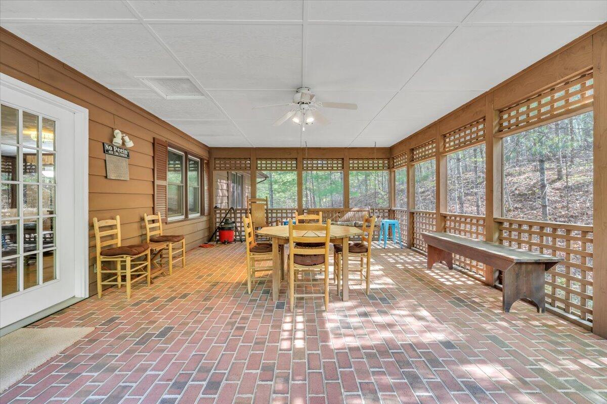3878 Harborwood Road Salem, VA 24153 - Photo 26 of 60 a living room with furniture a dining table and a floor to ceiling window