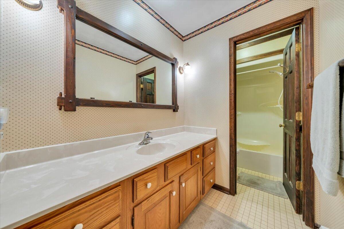 3878 Harborwood Road Salem, VA 24153 - Photo 31 of 60 a bathroom with a sink a mirror and a shower