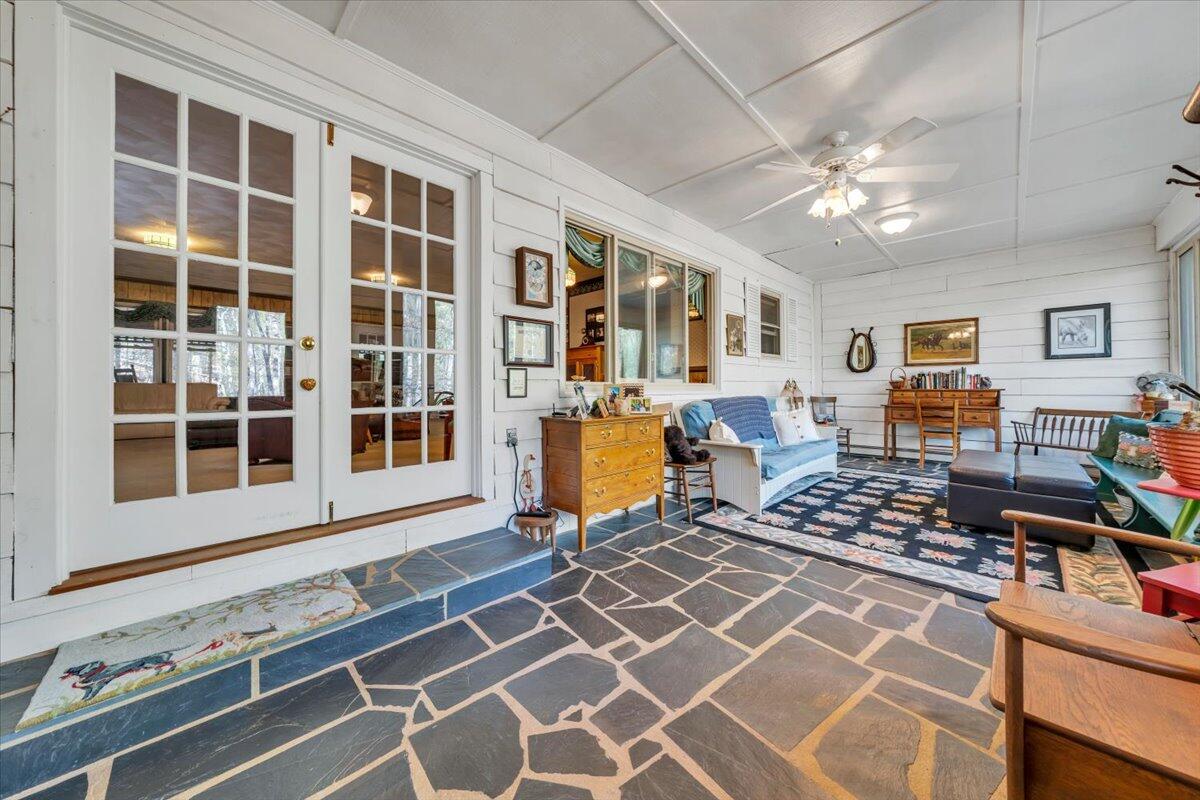 3878 Harborwood Road Salem, VA 24153 - Photo 4 of 60 a living room with balcony a dining table and chairs with wooden floor